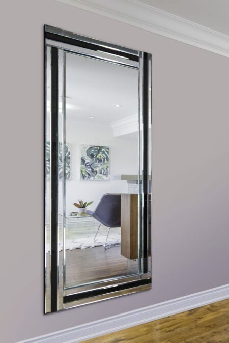 Large black full length mirror with bevelled glass frame hung on a grey living room wall